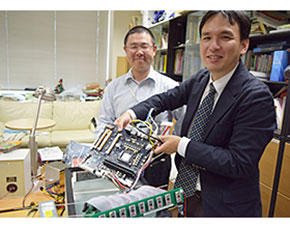 基板を実験用水槽に入れる鯉渕氏